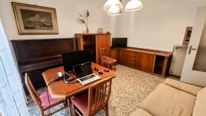 een woonkamer met een bureau en een laptop. bij Casa Riverbero in Novara