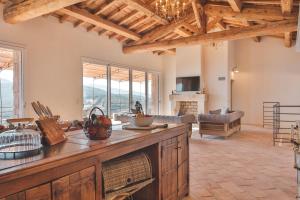 a large living room with a kitchen with a table at Les Demeures de Piana in Piana