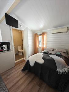 um quarto com uma cama grande e uma casa de banho em Aava Sky Village Aurinkomaja em Aavasaksa