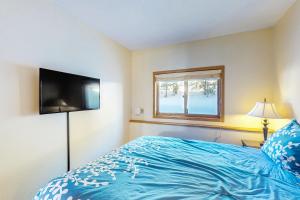 a bedroom with a blue bed and a window at Timber Ridge 504B in Silverthorne