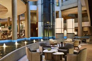 a lobby with chairs and tables in a building at The Westin Bonaventure Hotel & Suites, Los Angeles in Los Angeles