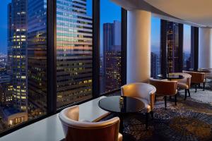 eine Bar mit Stühlen und Tischen und Stadtblick in der Unterkunft The Westin Bonaventure Hotel & Suites, Los Angeles in Los Angeles