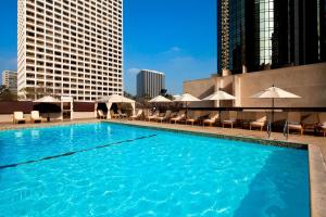 a large pool with chairs and umbrellas on a building at The Westin Bonaventure Hotel & Suites, Los Angeles in Los Angeles