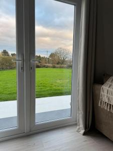 a sliding glass door with a view of a field at The Pod @ Essex House 