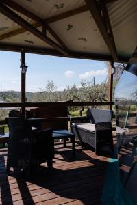 a patio with chairs and a table on a deck at La Cupola dei Trabocchi in Torino di Sangro