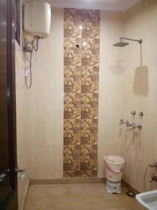 a bathroom with a shower with a toilet and a sink at Hotel Royal Plaza B&B in New Delhi