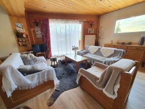 a living room with two couches and a table at Lautaret 5 - C5 - Appart spacieux vue - 10 pers in Les Deux Alpes