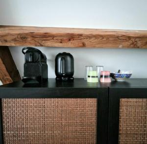 a counter with a coffee maker and glasses on it at Six Boutique Hotel in Haarlem