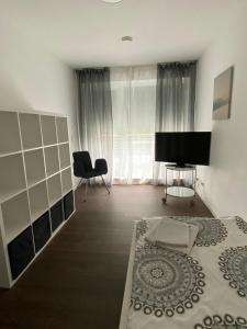 1 dormitorio con 1 cama y TV de pantalla plana en Modernes Ferienhaus mit 2 Balkonen, Terrasse und Garten !, en Bochum