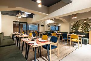 a restaurant with tables and yellow chairs and tablesktop at ibis Istanbul Sisli in Istanbul