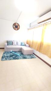 a living room with a couch and a rug at NK hostel P2 16/30 in Ban Song Hong