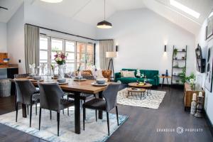 a dining room and living room with a table and chairs at Stunning LUX Scandinavian style apt for 5 Parking - Keepers Cottage in Poole