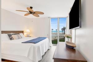 a bedroom with a bed and a ceiling fan at Perdido Sun Unit 116 in Pensacola