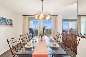 a dining room with a long table and chairs at Perdido Sun Unit 116 in Pensacola