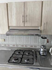 a kitchen with a stove top with a blender at apartment in neiva goliat in Neiva
