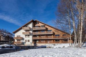 a large building with snow in front of it at St Christophe - 21B - Studio pied de piste - 4 per in Les Deux Alpes
