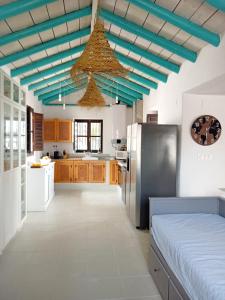 a kitchen with a blue ceiling and a refrigerator at Casa Rio in Pinos del Valle