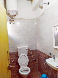a bathroom with a toilet and a sink at MS Comforts Mahadevapura in Bangalore +31 photos