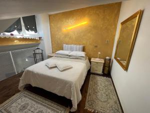 a bedroom with a bed with two towels on it at Casa di Adelaide in Schio