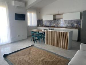 a kitchen and dining room with a table and chairs at Sikuli Home in Oliveri
