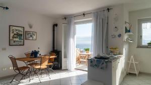 a kitchen and dining room with a table and chairs at Green and Blue vista mare Cala Gonone in Cala Gonone