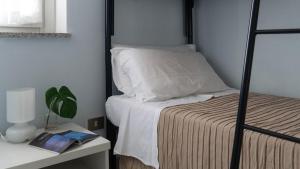 a bedroom with a bed and a table with a lamp at Green and Blue vista mare Cala Gonone in Cala Gonone