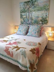 1 dormitorio con 1 cama con una pintura en la pared en Apartamento La Coveta de Guadalest, en Guadalest