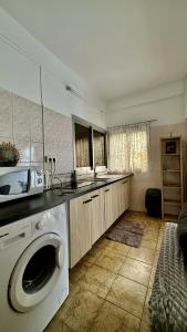 a kitchen with a washing machine in a kitchen at Studio Loulou, Tsoundzou2 in Mamoudzou