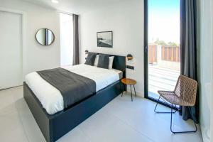a bedroom with a large bed and a balcony at LEA LUXURY GOLF HOUSE in Caleta De Fuste +10 photos
