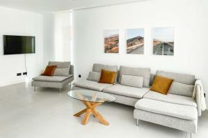 a living room with a couch and a coffee table at LEA LUXURY GOLF HOUSE in Caleta De Fuste