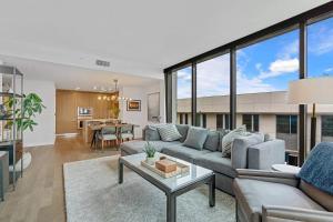 a living room with a couch and a table at Santa Monica Two Bedroom Apartment With Amazing Views in Los Angeles