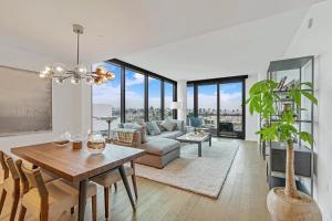 a living room with a table and a couch at Santa Monica Two Bedroom Apartment With Amazing Views in Los Angeles
