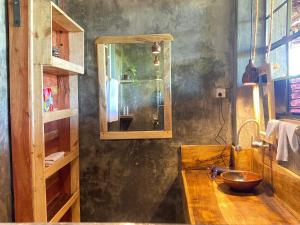 a bathroom with a wooden counter and a mirror at Mount Kilimanjaro 360 view Cottage in Uru