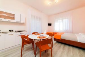 a small room with a bed and a table and chairs at Estate4home - Casa Laura in Sant'Agnello