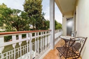 a balcony with a table and chairs and trees at Estate4home - Casa Laura in Sant'Agnello