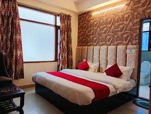 a bedroom with a large bed with a window at The White House Shimla in Shimla