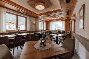 a restaurant with tables and chairs and windows at Forstauerwirt - mit Herz und Genuss in Forstau