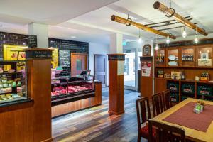 a restaurant with a table and a counter with food at Landgasthof Zur Tanne in Waltershausen