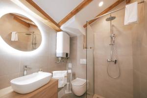 a bathroom with a toilet and a sink and a shower at Mascheroni Luxury Rooms in Dubrovnik +26 photos
