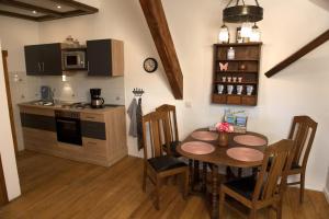 a kitchen with a table and chairs and a kitchen with a stove at Ferienwohnung Bonishof in Westerholt