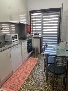 a kitchen with a table and a table and chairs at Art Gallery Apartment in Porto