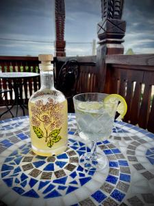 a bottle of lemonade sitting on a table with a drink at The Carpathian Lodge in Runcu