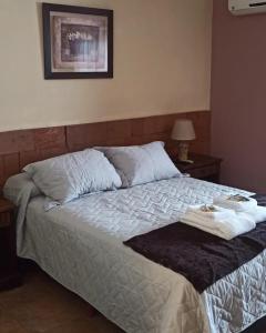 a bedroom with a bed with two towels on it at Portal del Sol in San Ignacio