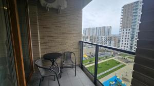a balcony with a table and chairs and a view of a city at Vision Apartments Gdańsk in Gdańsk