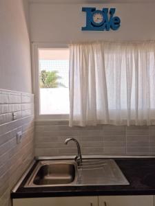 a kitchen with a sink and a window at Piccola Oasi in Corralejo