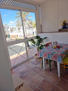 a dining room with a table and a view of the ocean at Piccola Oasi in Corralejo