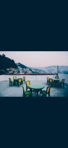 a group of tables and chairs sitting on a roof at Hotel Mountain Meadows in Darjeeling