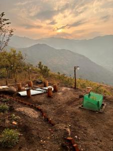 a view of a mountain with a green bucket at Hide away valley in Kodaikānāl