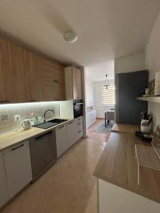 a kitchen with white cabinets and a counter top at Apartment GeoMo in Mostar