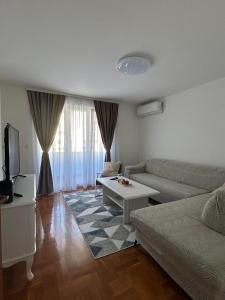 a living room with a couch and a table at Apartment GeoMo in Mostar
